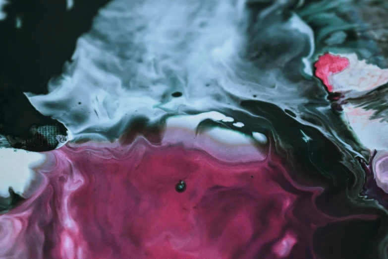a close up of a pink and black liquid, trending on unsplash, oil inks, pink white turquoise, red liquid, currents