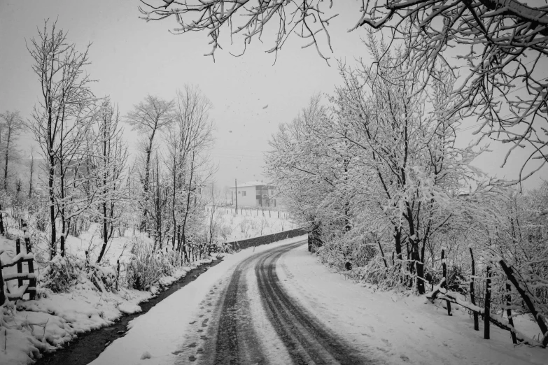 a black and white photo of a snowy road, a black and white photo, by Luca Zontini, pixabay, savrasov, snowy apennines, photo for magazine, photo on iphone