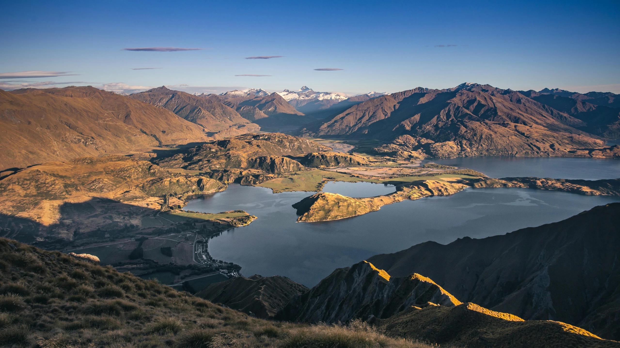 a large body of water surrounded by mountains, by Peter Churcher, pexels contest winner, hurufiyya, waneella, afternoon light, high view, inlets