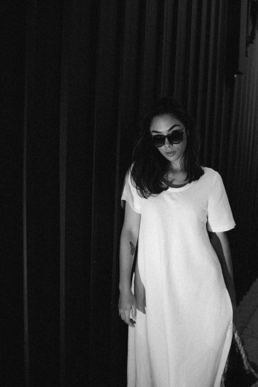 a black and white photo of a woman in a white dress, tumblr, postminimalism, wearing shades, vanessa morgan, white tshirt, asthetic