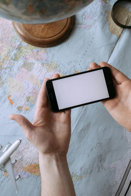 a close up of a person holding a cell phone, a picture, white map library, 2 5 6 x 2 5 6 pixels, traveller, mapbox