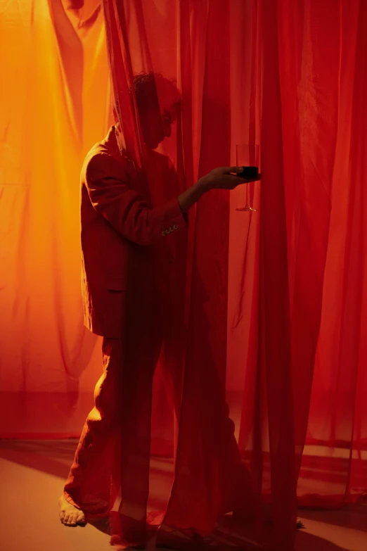 a man standing in front of a red curtain, inspired by Georges de La Tour, pexels contest winner, orange mist, showstudio, exiting from a wardrobe, instagram picture