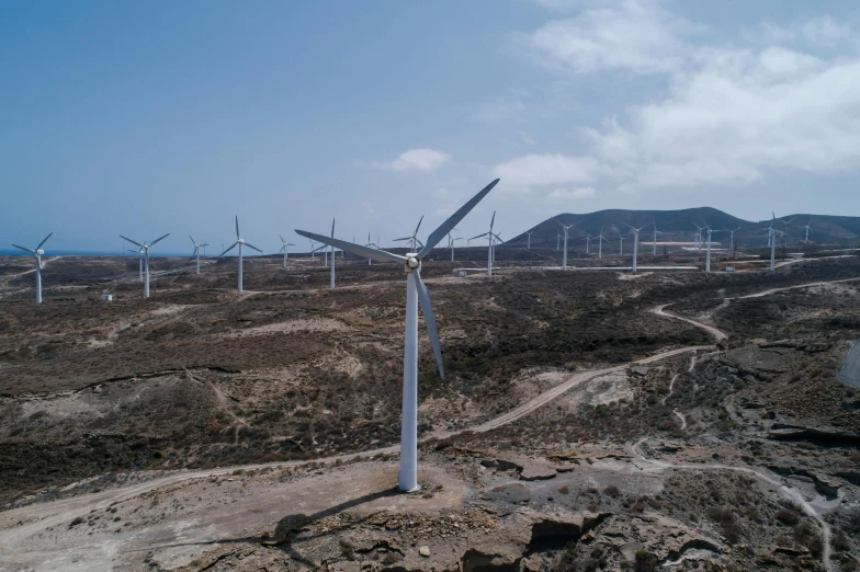 a group of wind turbines sitting on top of a dirt field, pexels contest winner, hurufiyya, in socotra island, high quality product image”