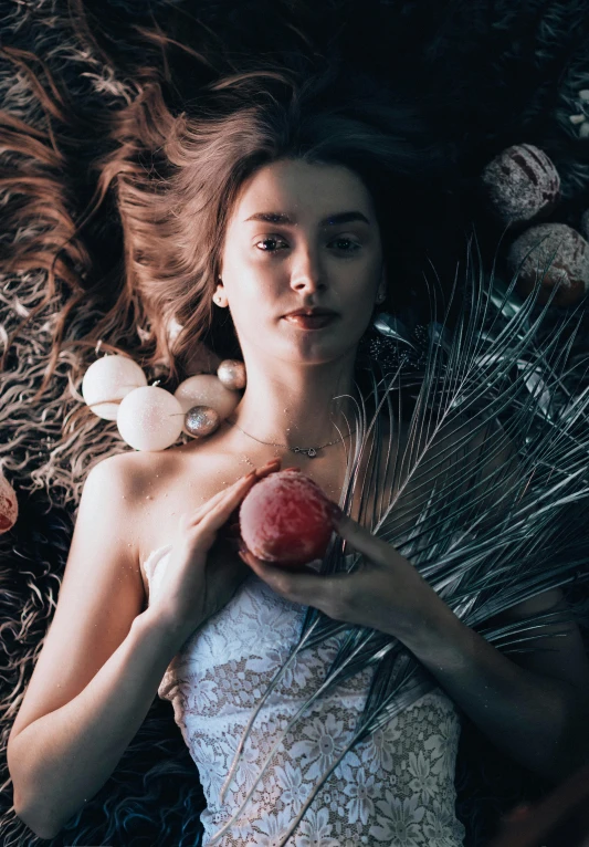 a woman laying on the ground holding an apple, inspired by Elsa Bleda, unsplash contest winner, renaissance, corals are gemstones, portrait of teenage aphrodite, beautiful composition 3 - d 4 k, anna nikonova aka newmilky