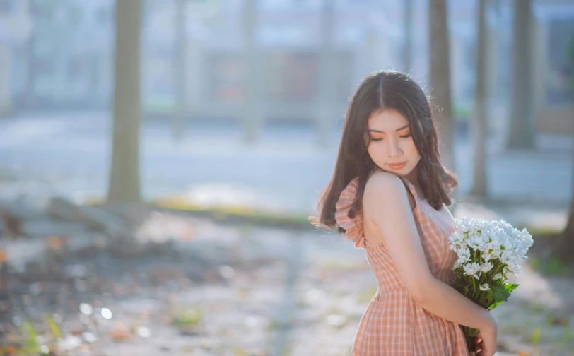 a woman in a dress holding a bunch of flowers, by Tan Ting-pho, pexels contest winner, aestheticism, young cute wan asian face, sad scene, background image, sunny atmosphere