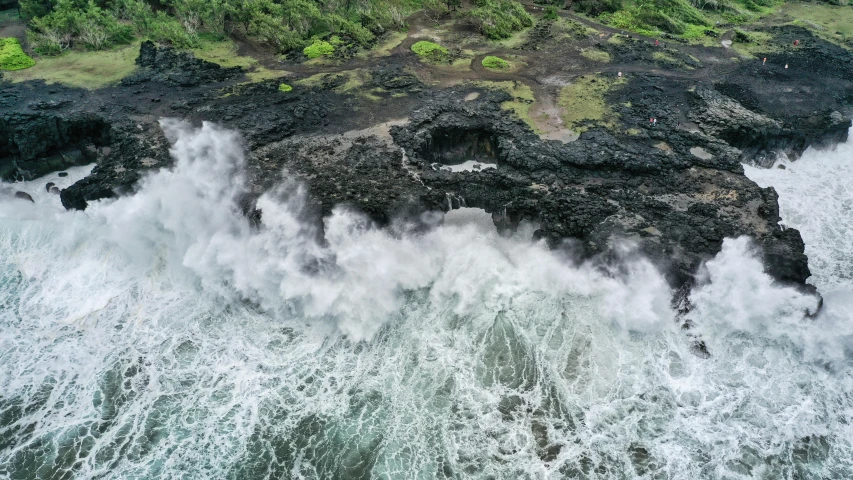 a large body of water next to a lush green hillside, an album cover, pexels contest winner, dangerous waves, drone photograpghy, white lava, nat geo