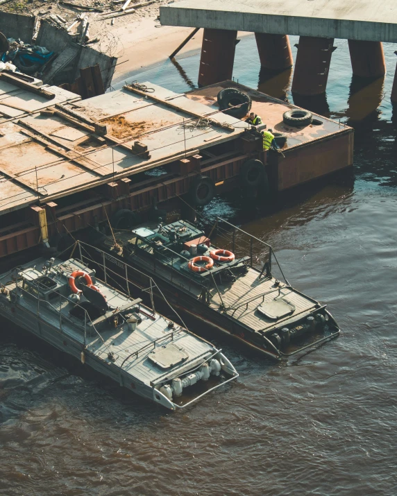 a couple of boats that are sitting in the water, mechanical vehicles, a high angle shot, military-grade, stacked image