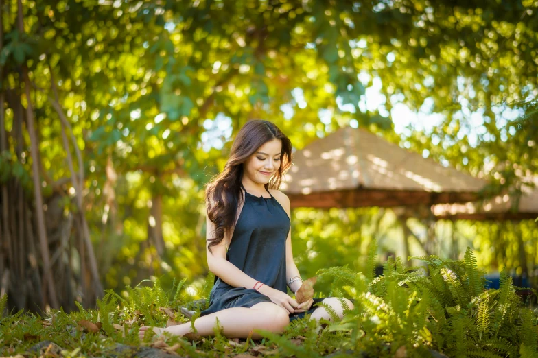 a woman sitting in the grass with her legs crossed, a portrait, unsplash, beautiful asian woman sitting, sitting on a leaf, 15081959 21121991 01012000 4k, big island