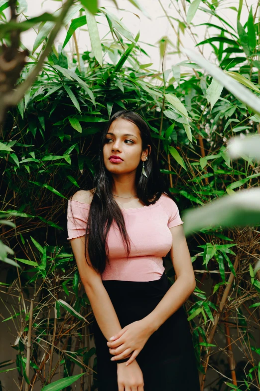 a woman in a pink top and black skirt, by Max Dauthendey, pexels contest winner, dense with greenery, indian girl with brown skin, 18 years old, leaked image