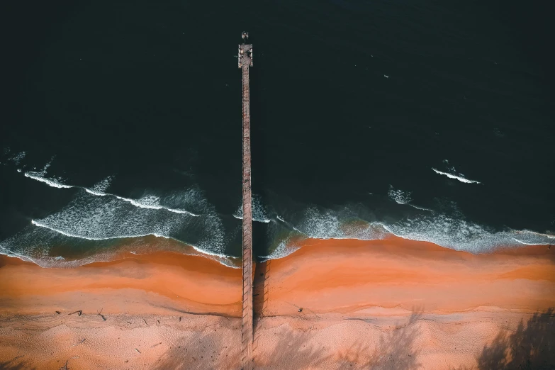 a large body of water next to a beach, by Eglon van der Neer, pexels contest winner, black and terracotta, airborne view, near a jetty, 15081959 21121991 01012000 4k