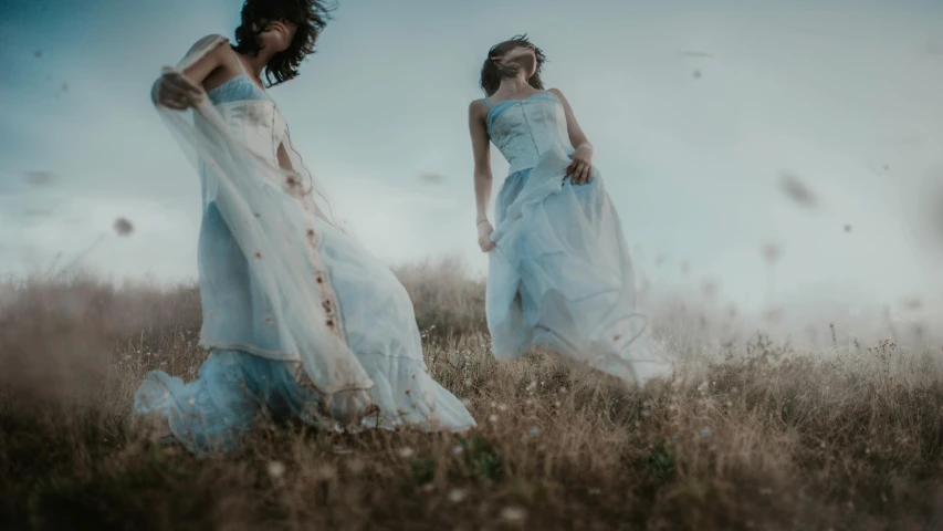 two women in blue dresses standing in a field, an album cover, pexels contest winner, wearing a flowing dress, fashion shoot 8k, ethereal!!!!!!!, walking down