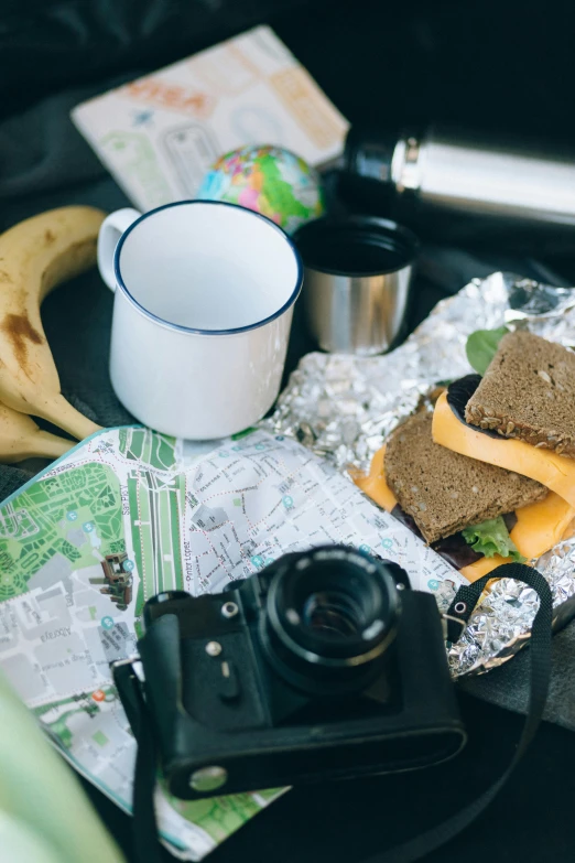 a close up of a plate of food on a table, a still life, unsplash, panfuturism, tourist map, toast, adventure gear, inside of a car