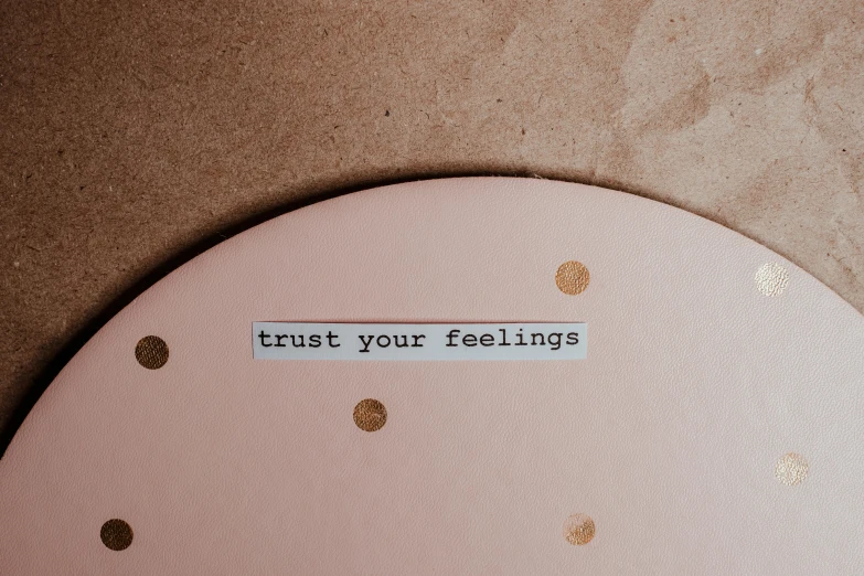 a clock with the words trust your feelings written on it, by Dulah Marie Evans, trending on pexels, faded pink, etsy stickers, bottom body close up, alessio albi