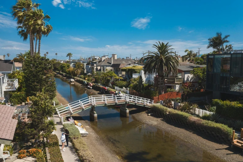 a bridge over a river in a residential area, by Carey Morris, unsplash, renaissance, santa monica beach, canal, on a sunny day, flatlay