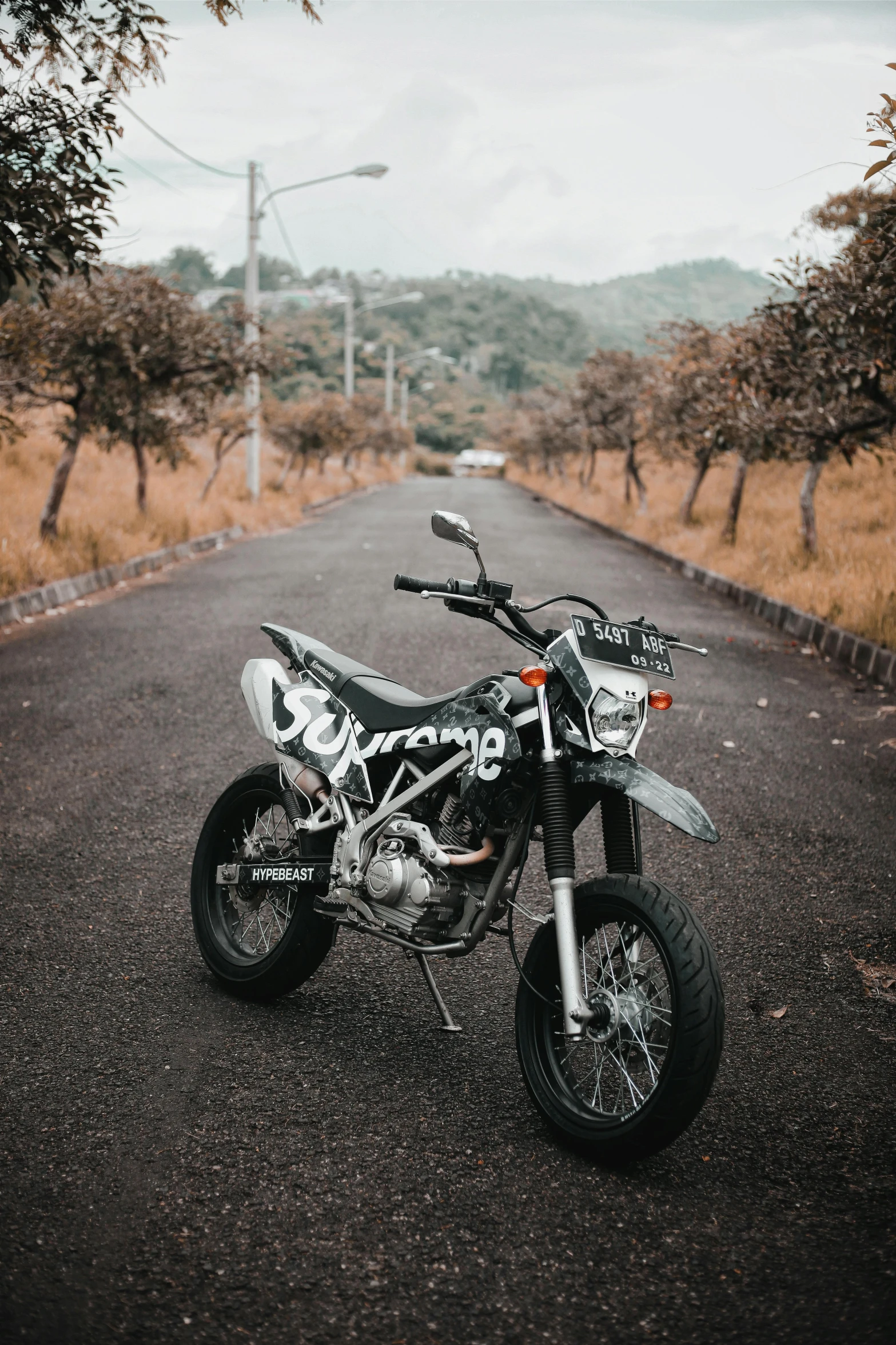 a motorcycle parked on the side of a road, inspired by Alex Petruk APe, pexels contest winner, 2 5 6 x 2 5 6 pixels, motocross bike, grey, spotted
