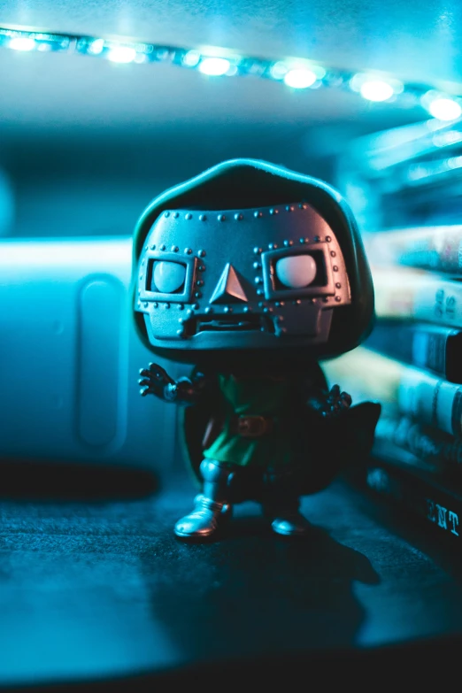 a close up of a toy on a table, by Adam Marczyński, pexels contest winner, doctor doom, as a funko pop!, standing on a shelf, calavera