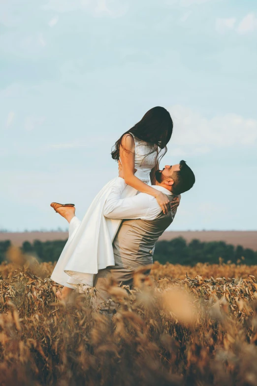 a man carrying a woman in a field, pexels contest winner, elegant floating pose, white, overlooking, brown