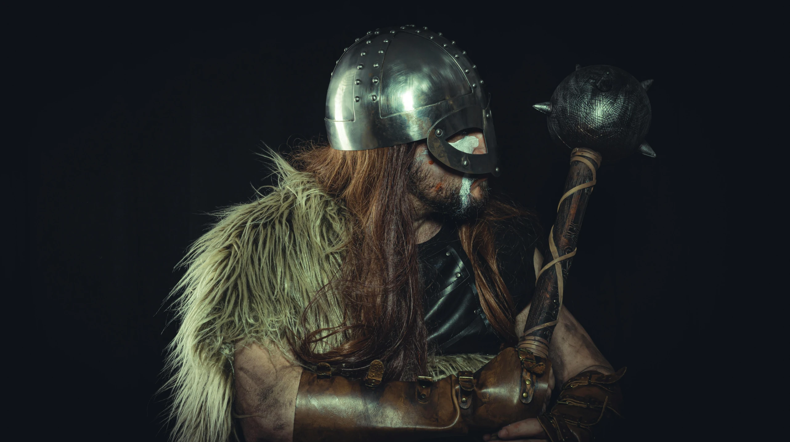a man with long hair wearing a helmet and holding an axe, inspired by Þórarinn B. Þorláksson, pexels contest winner, fur armor, cosplay photo, vintage photo