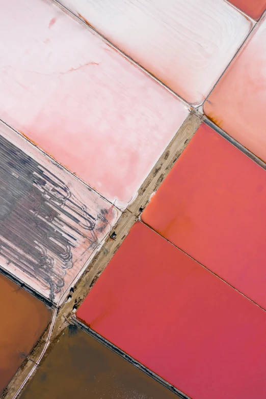 an aerial view of a colorful patch of land, inspired by René Burri, trending on unsplash, color field, glass panes, rose quartz, glazed ceramic, soft red tone colors