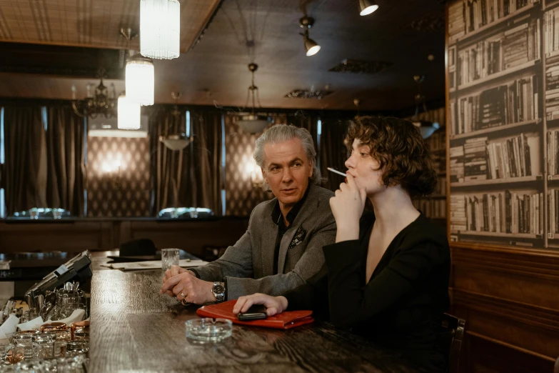 a man and a woman sitting at a bar, a portrait, by Dan Frazier, pexels contest winner, jim jarmusch, hunting, calmly conversing 8k, family photo