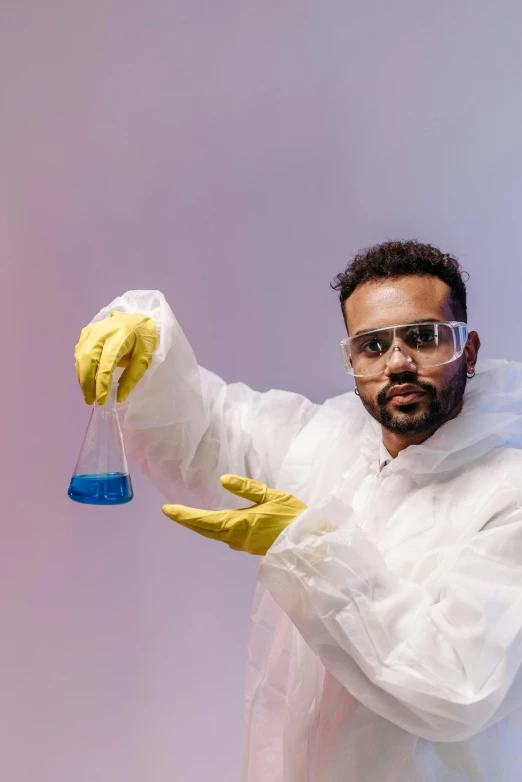 a man in a lab coat holding a test tube, an album cover, pexels contest winner, beakers of colored liquid, wearing blue robe, dr zeus, gif