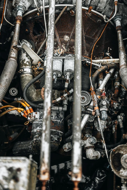 a close up of an old engine on a train, by Daniel Lieske, pexels contest winner, auto-destructive art, robot made of truck parts, wide angle shot from above, hoses:10, inside of a tokyo garage