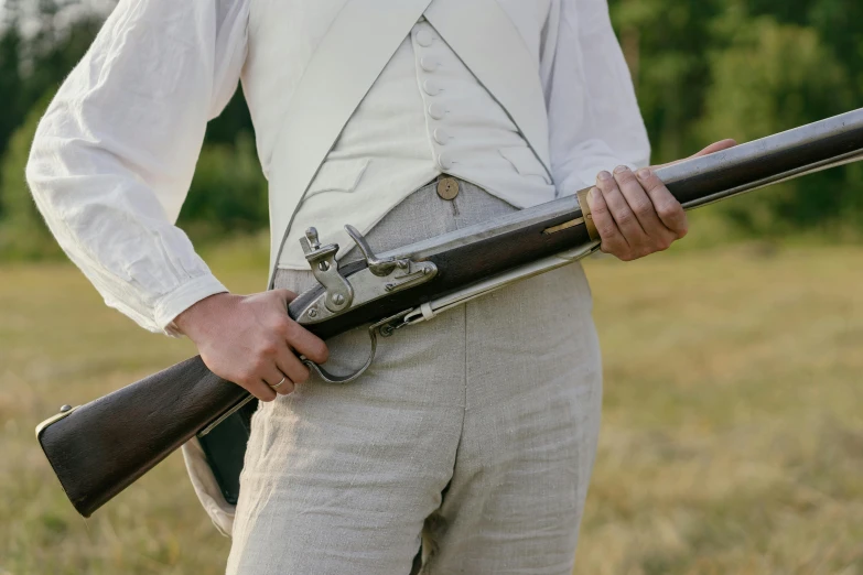 a man standing in a field holding a rifle, inspired by Charles Codman, unsplash, white waistcoat, historically accurate, close up photo, live-action archival footage