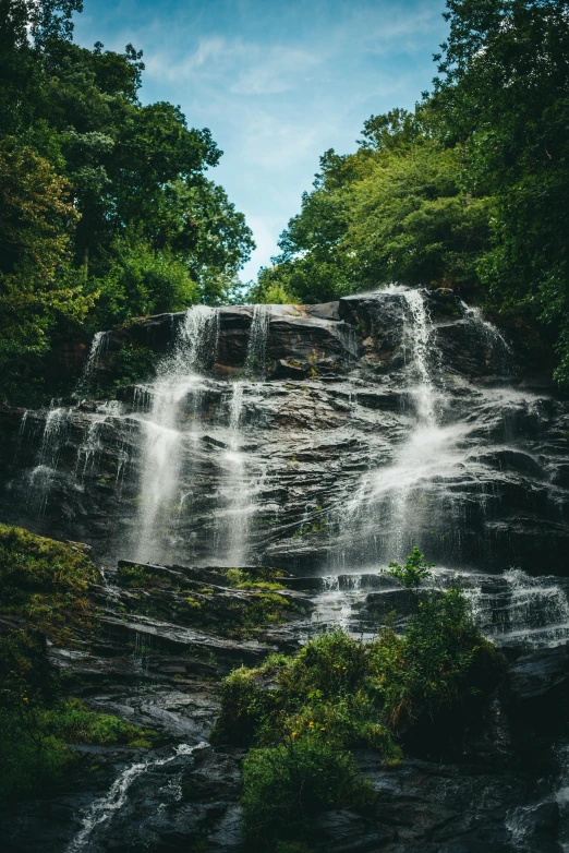 a waterfall in the middle of a forest, in the hillside, stunning lines, highly polished, front facing