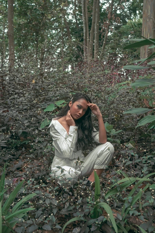 a woman sitting in the middle of a forest, an album cover, unsplash, sumatraism, wearing white pajamas, cindy avelino, portrait image, lush foliage