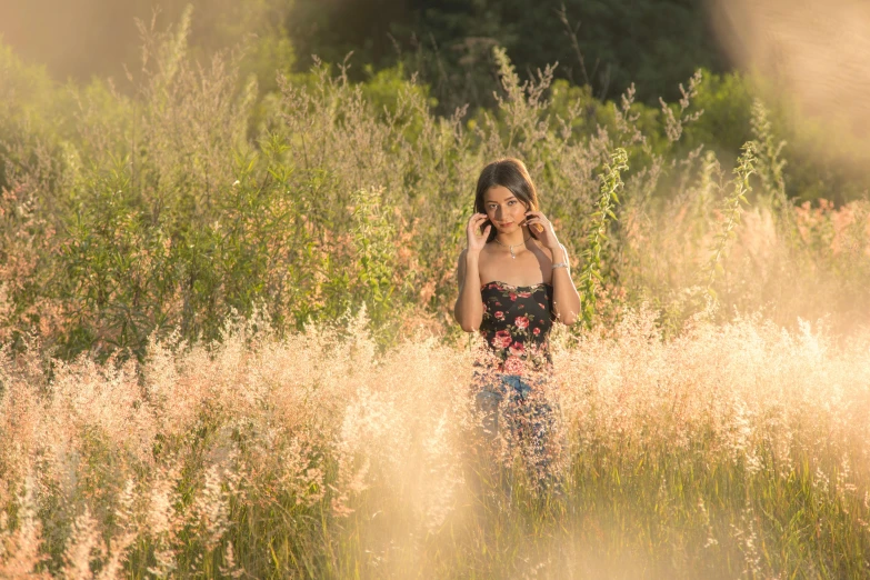 a woman standing in a field talking on a cell phone, unsplash, romanticism, medium format, hailee steinfeld, portrait image