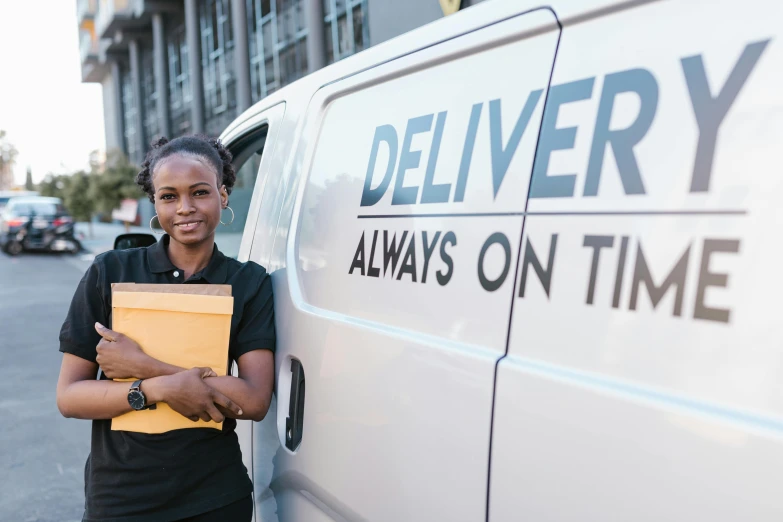 a woman standing in front of a delivery van, photo of a black woman, day time, avatar image