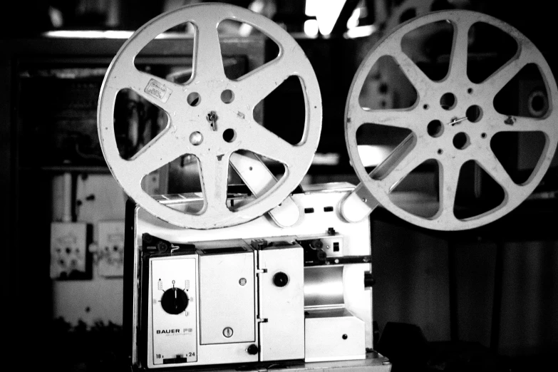 a black and white photo of a movie projector, by John Hutton, imax 35 mm footage