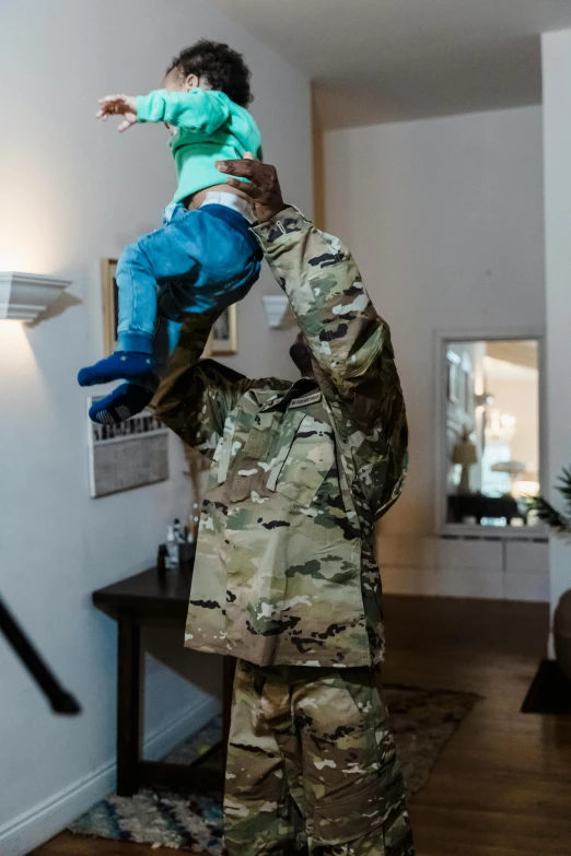 a soldier holding a child up in the air, by Gen Paul, unsplash, visual art, full costume, at home, face covered, 🚀🌈🤩