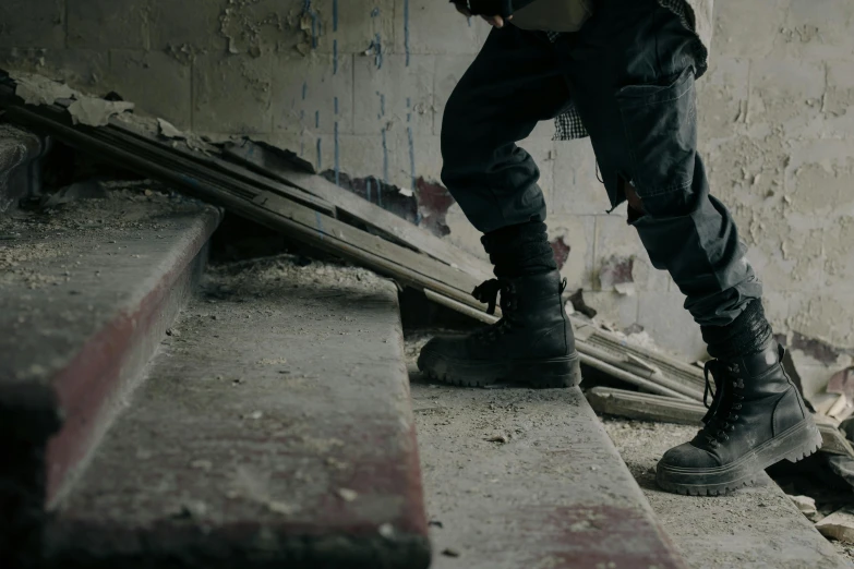 a man riding a skateboard down a flight of stairs, by Elsa Bleda, realism, military boots, standing in ruins, worksafe. cinematic, black