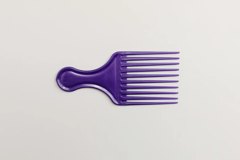 a purple comb sitting on top of a white table, glossy intricate design, short spout, pitchfork, nubian