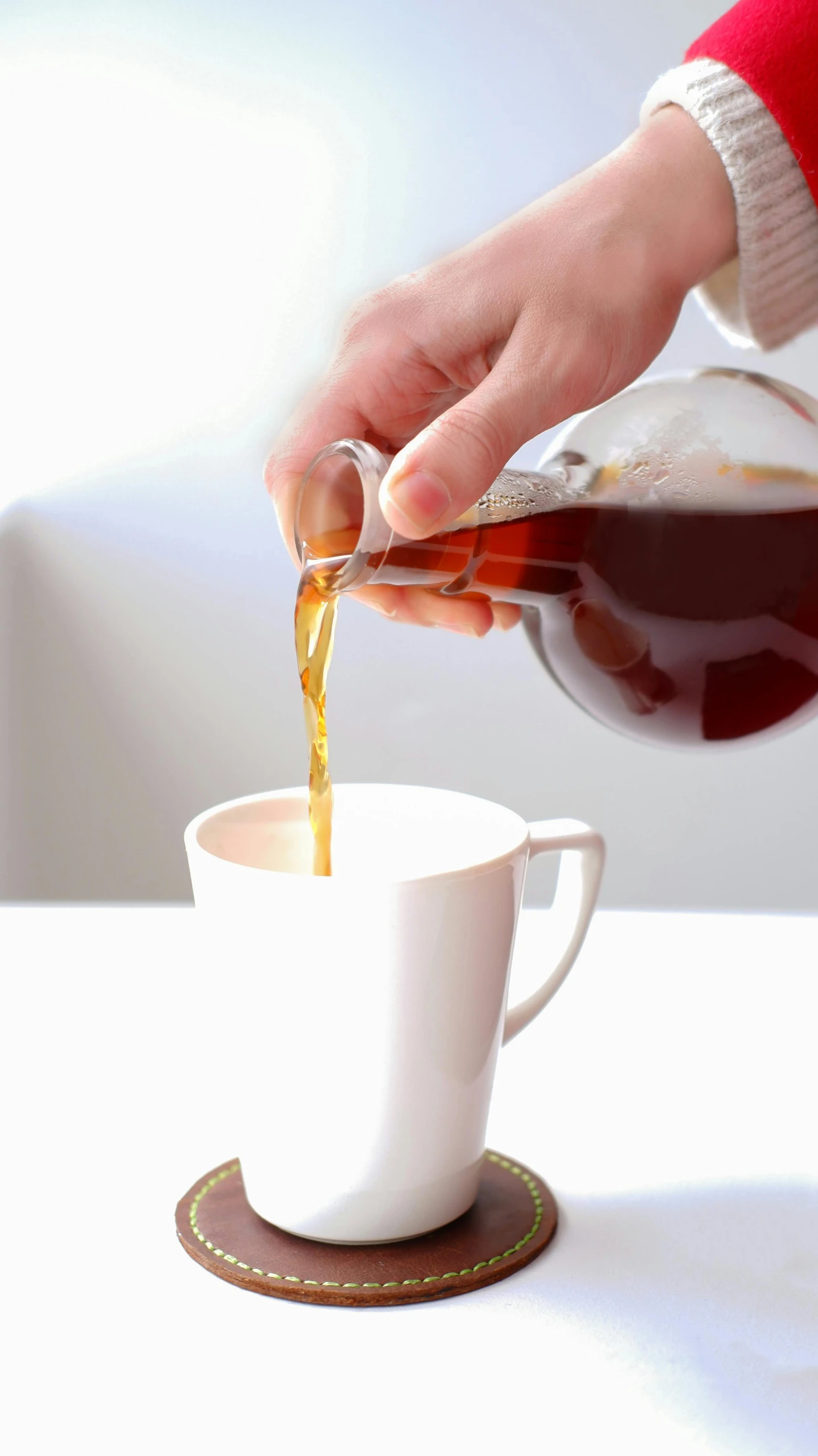 a person pouring coffee into a cup on a table, profile image, maple syrup, thumbnail, product shot