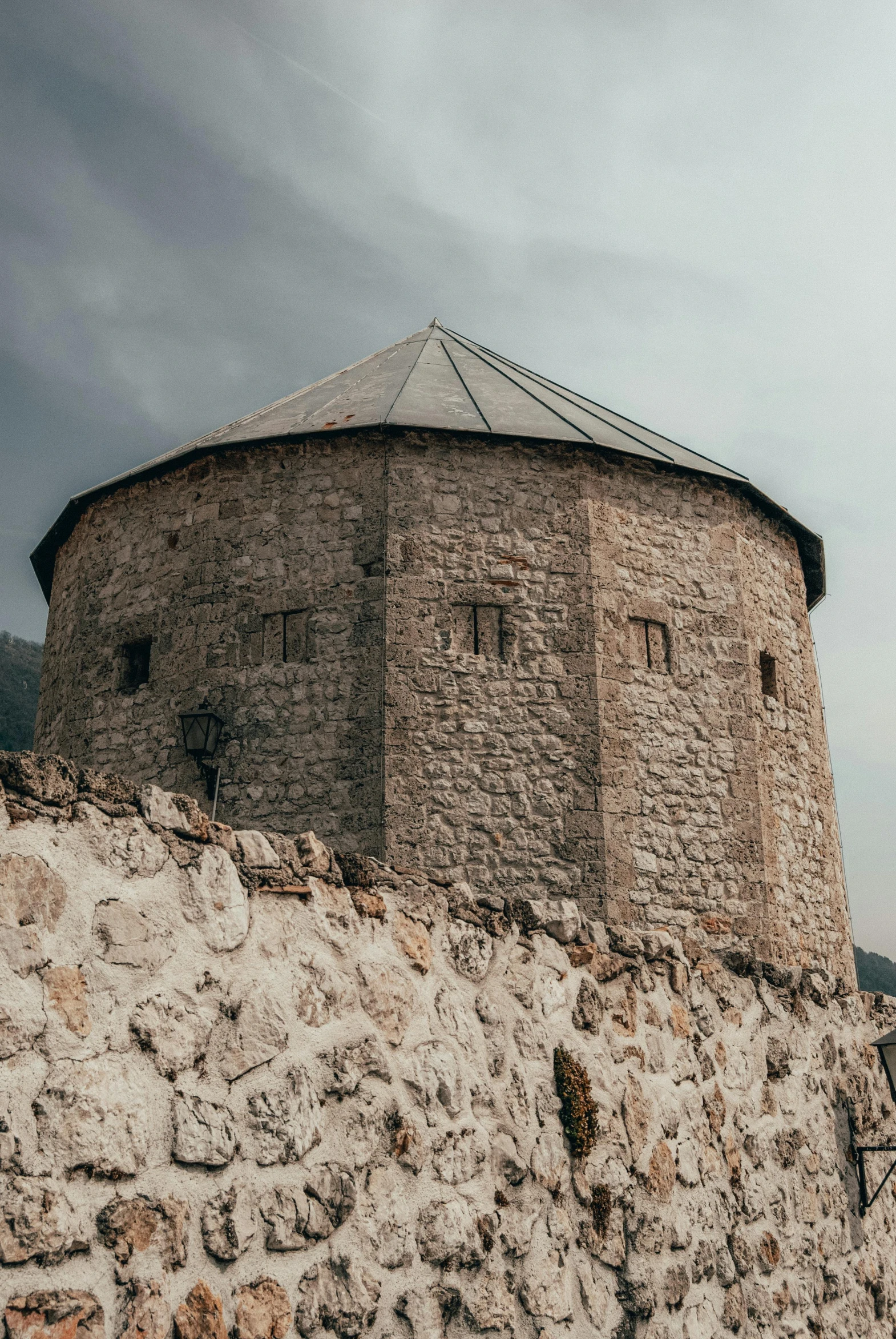 a stone building sitting on top of a hill, bosnian, rounded architecture, located in a castle, stern