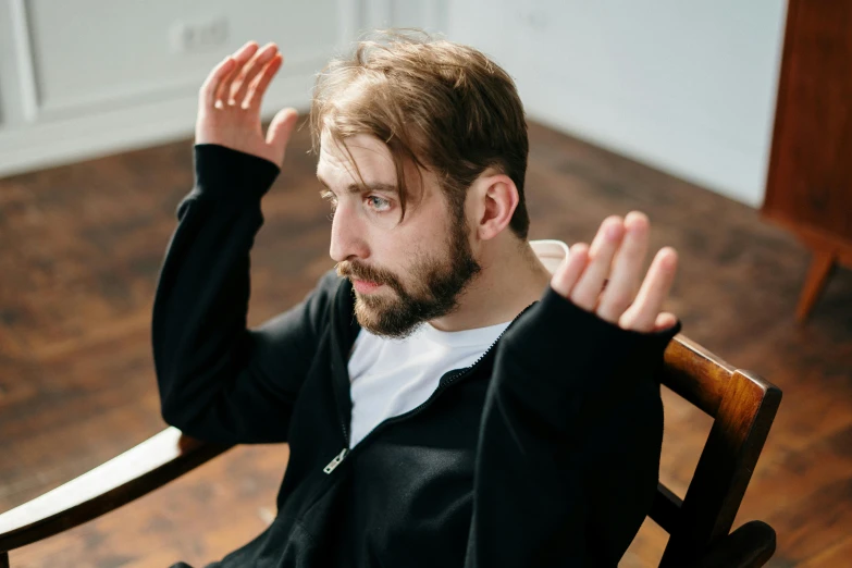 a man sitting in a chair with his hands in the air, by Hallsteinn Sigurðsson, pexels contest winner, renaissance, short dark blond beard, hasbulla magomedov, they reach into his mind, as well as scratches