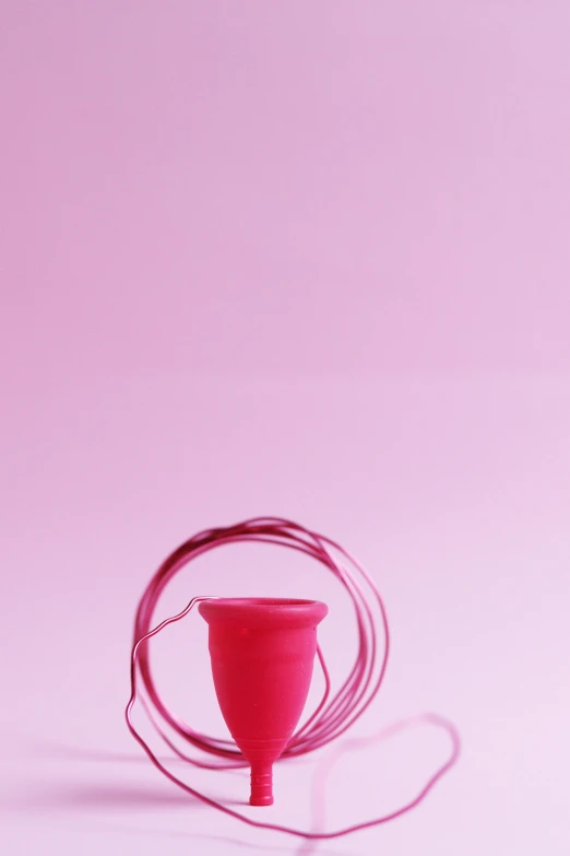 a red cup sitting on top of a pink table, plasticien, lasso, contracept, ( conceptual art ), promo image