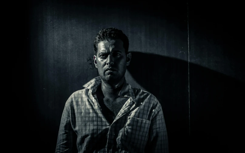 a black and white photo of a man in a shirt, a character portrait, inspired by Lee Jeffries, standing in a dimly lit room, intense dramatic hdr, promo image, instagram photo