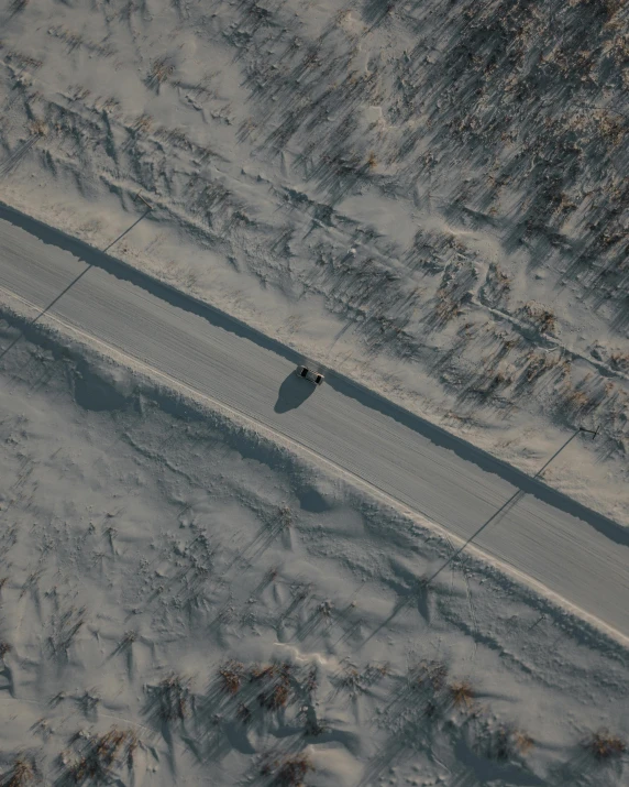 an aerial view of a snow covered road, an album cover, pexels contest winner, movie still 8 k, 2 people, gif, vehicle