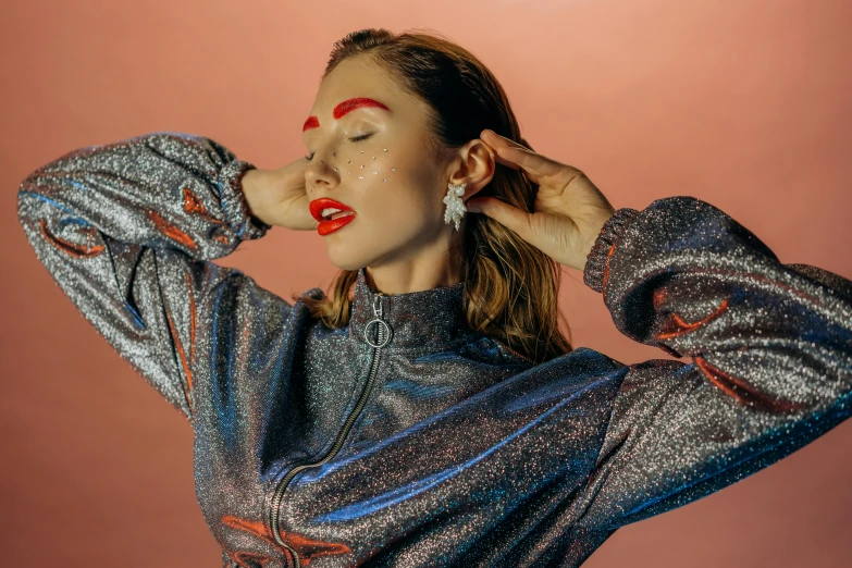 a woman with red lipstick posing for a picture, an album cover, by Julia Pishtar, trending on pexels, holography, wearing a track suit, giant earrings, studio shoot, in a space cadet outfit