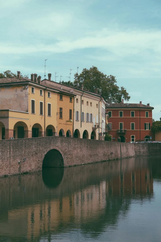 a group of buildings next to a body of water, inspired by Italo Mus, pexels contest winner, renaissance, old bridge, color graded, small town, high resolution photo