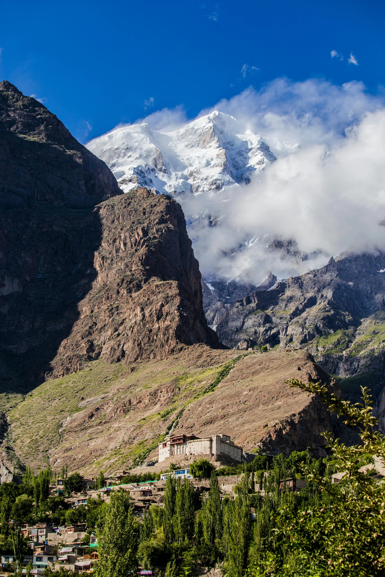 a view of a mountain with a village in the foreground, by Muggur, temple of the sun, in an epic valley, climbing, larapi