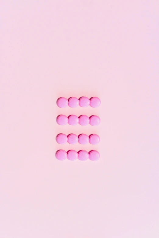 a bunch of pink pills sitting on top of a white surface, an album cover, by Attila Meszlenyi, trending on pexels, antipodeans, beautiful equations, ffffound, icon, contracept