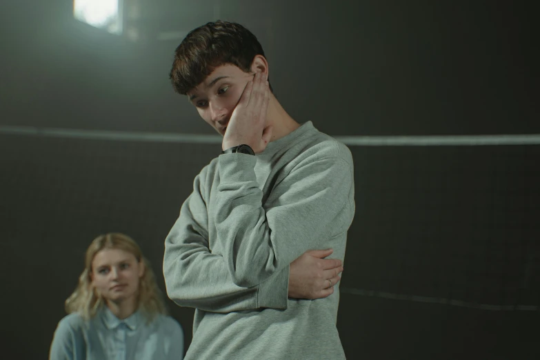 a couple of people standing next to each other, pexels contest winner, hyperrealism, teenage boy, disappointed, production still, wearing a tracksuit