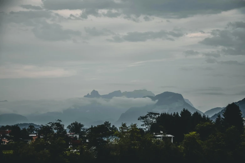 there is a plane that is flying in the sky, inspired by Elsa Bleda, pexels contest winner, romanticism, rainforest mountains, grey, view from the streets, today\'s featured photograph 4k