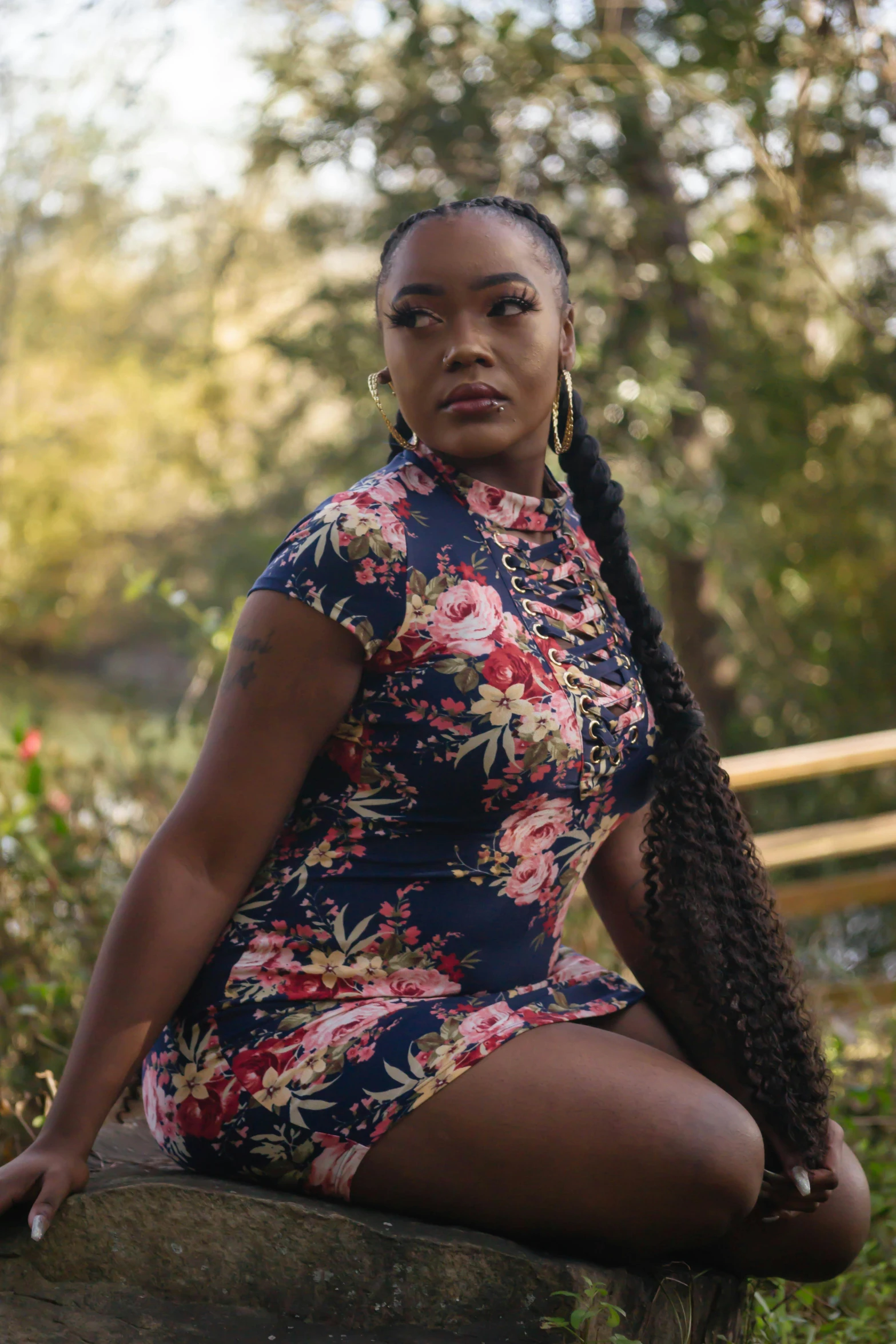 a woman sitting on top of a wooden bench, dressed in a flower dress, thick thighs, modeling, ( ( dark skin ) )