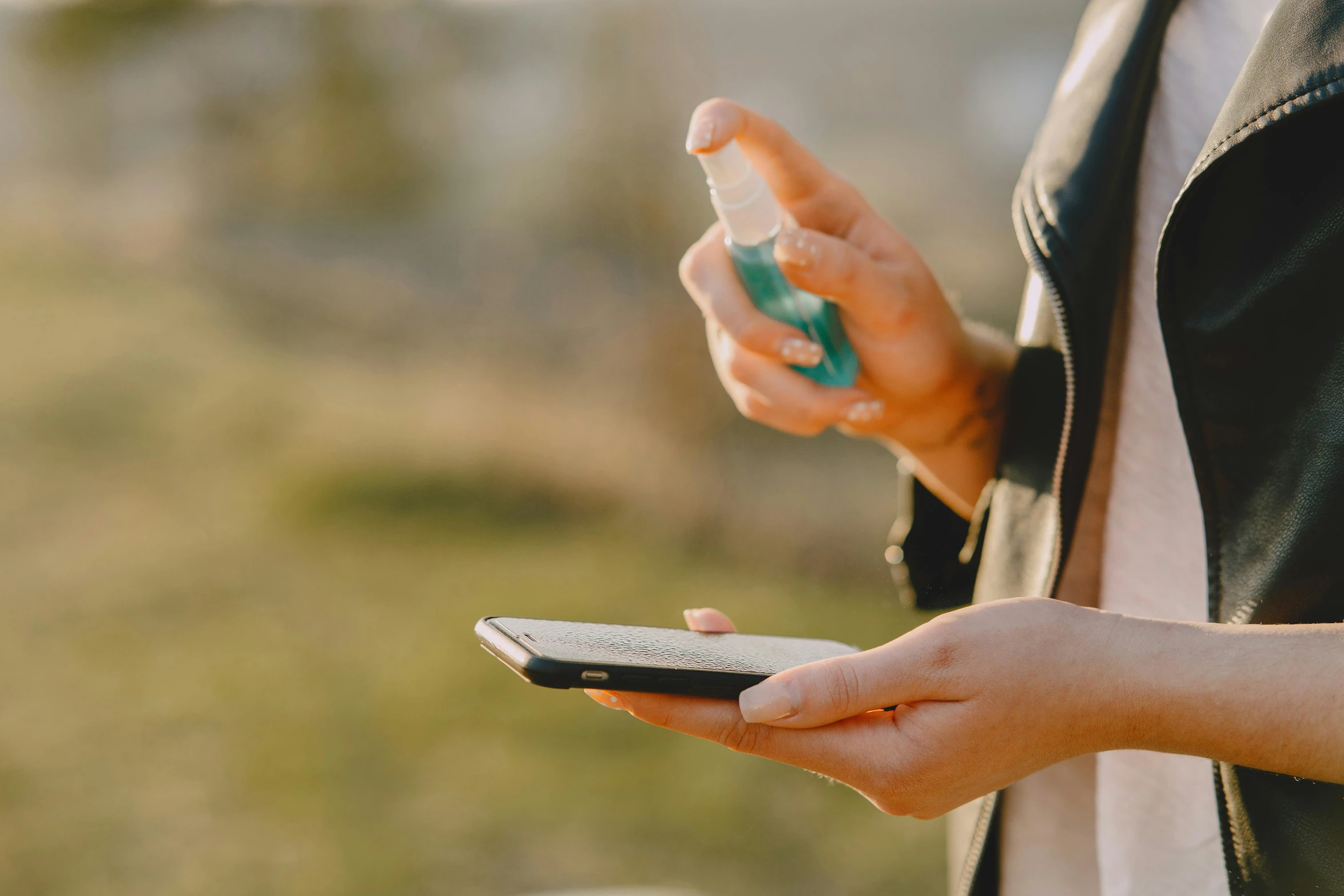 a close up of a person holding a cell phone, trending on pexels, spraying liquid, al fresco, skincare, avatar image