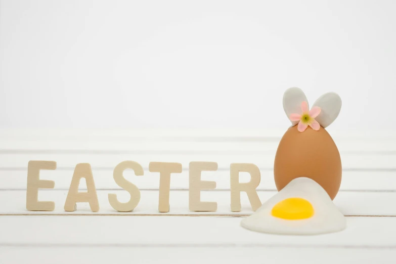 an egg sitting on top of a table next to the word easter, ears, illustration »